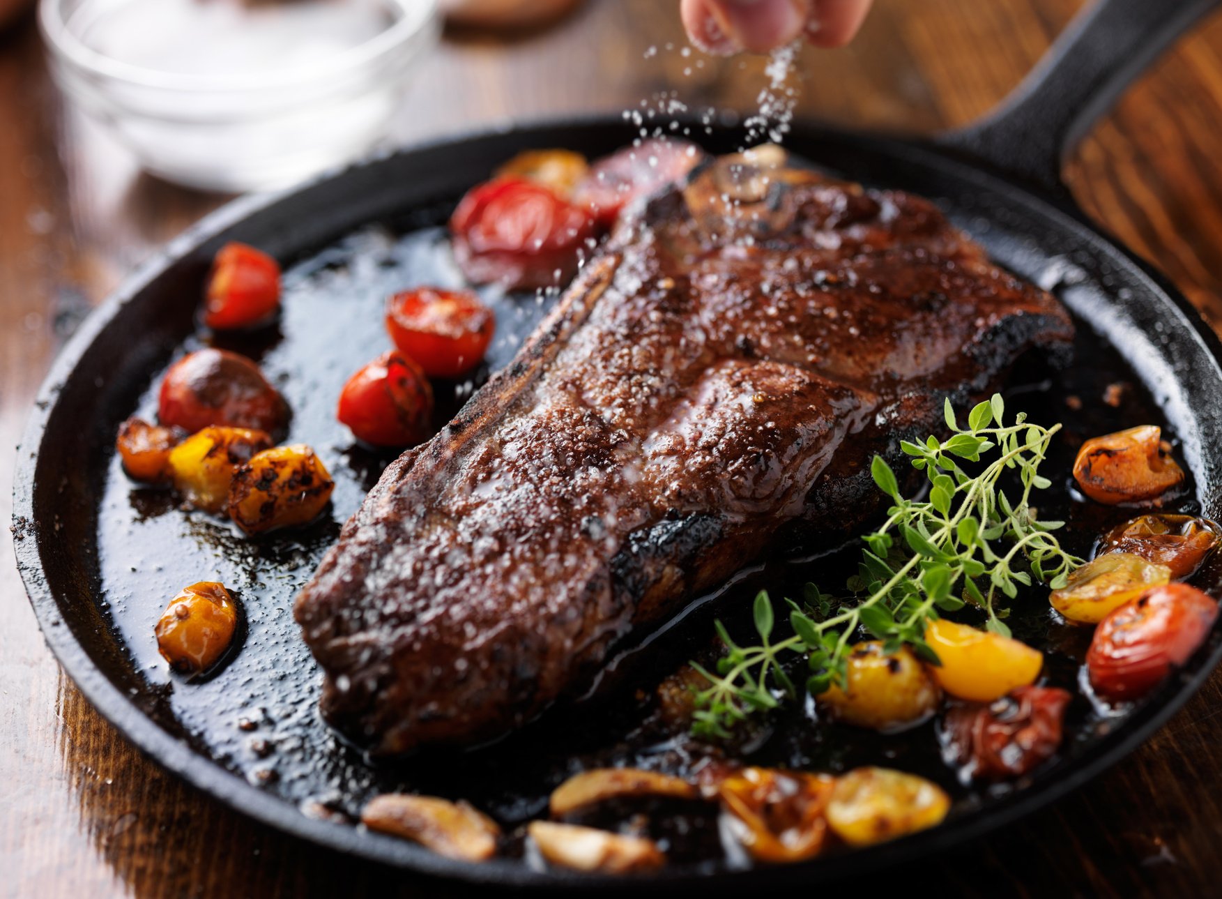 Sprinking Sea Salt on a Ny Strip Steak