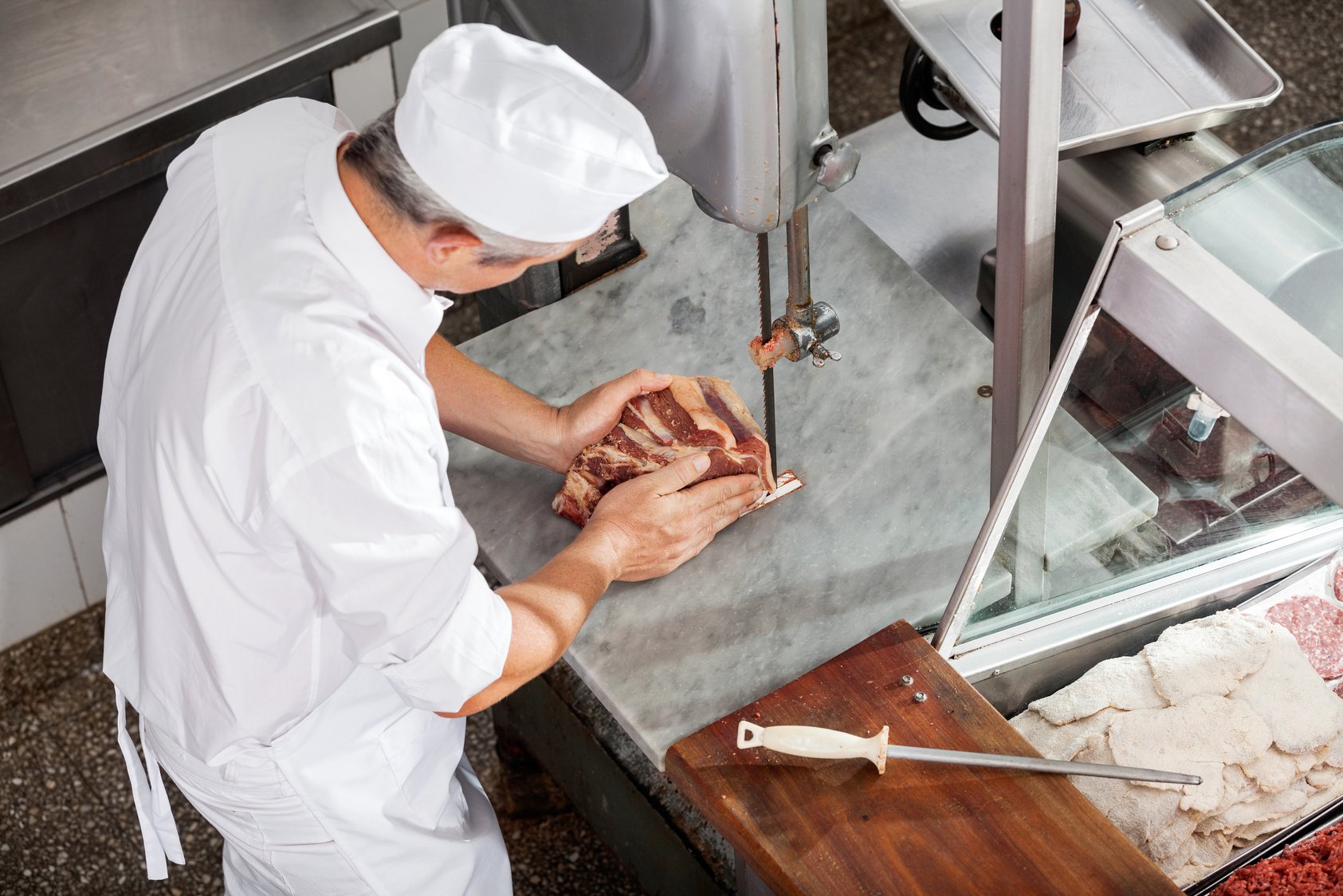 Butcher Cutting Meat with Bandsaw